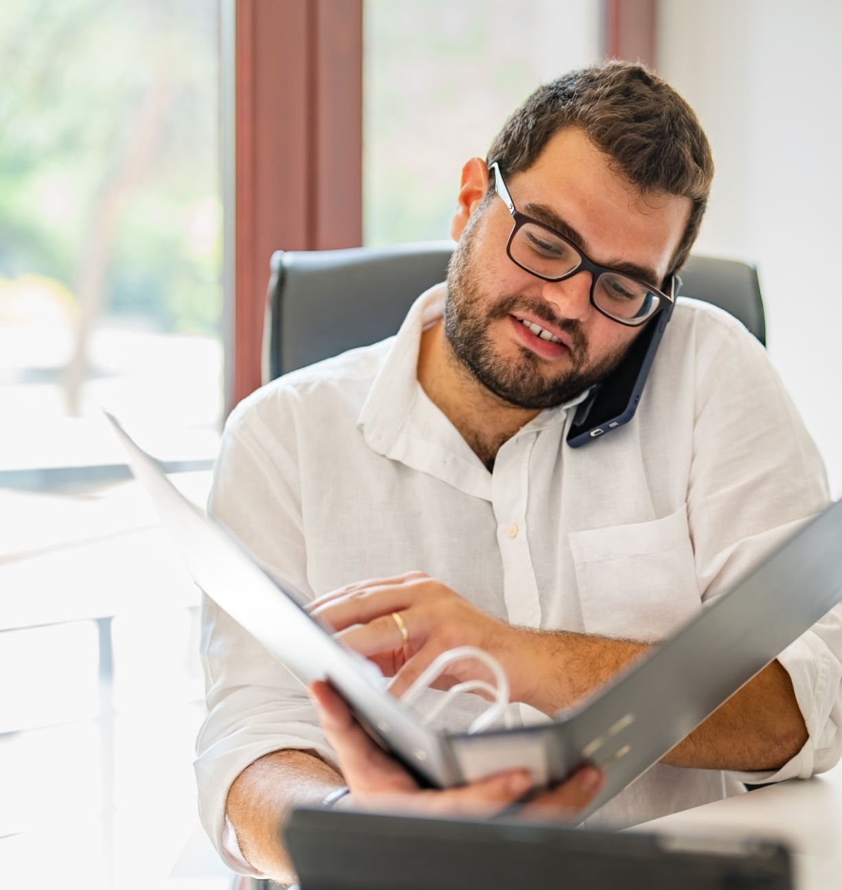 Young businessman working on document folder
